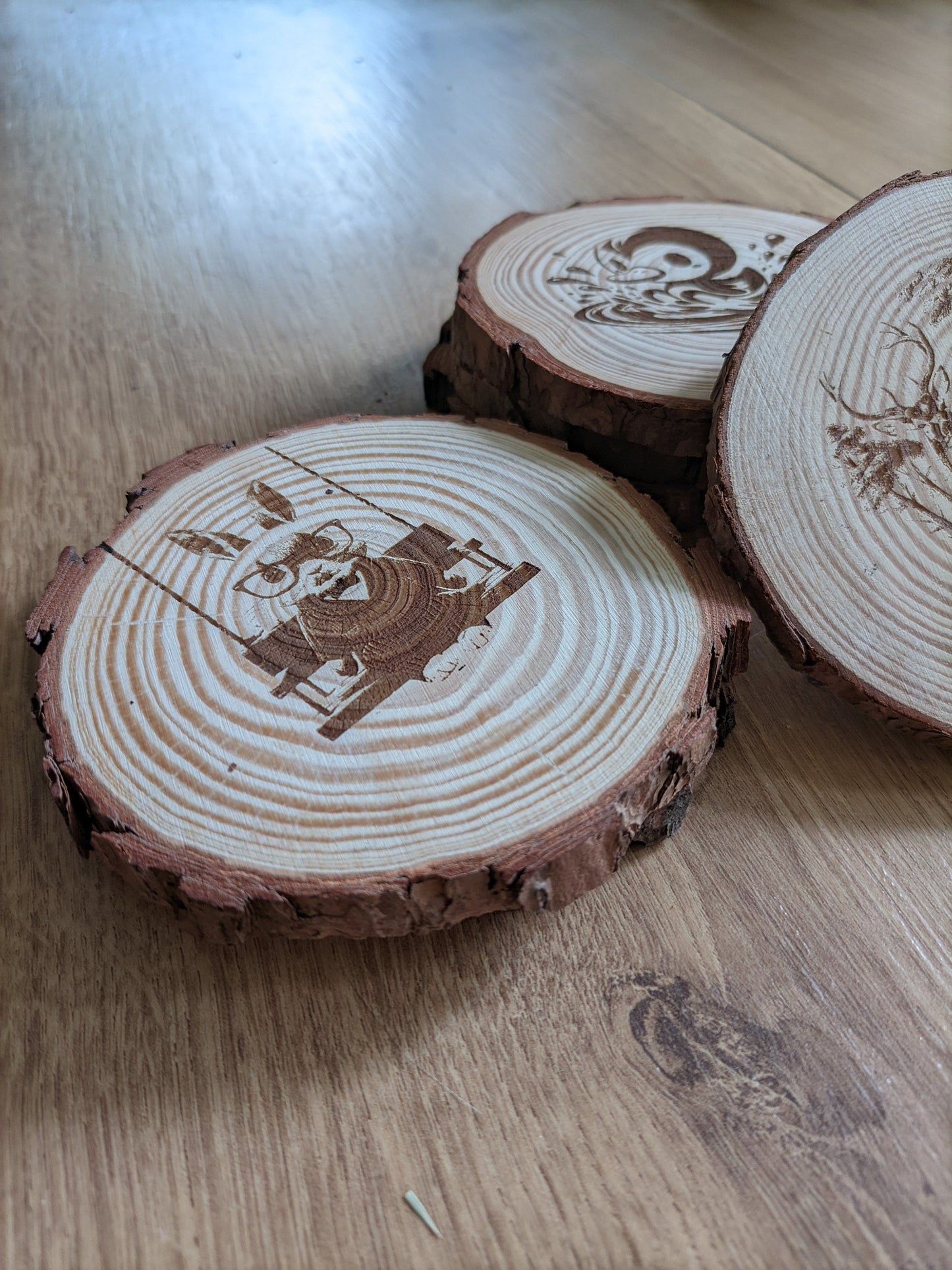 Natural wood coasters with artistic engravings