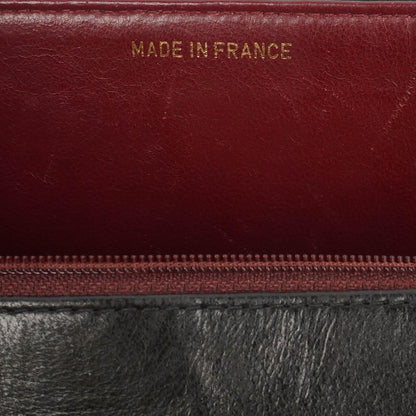 Chanel Kelly Flap Tasche aus schwarzem vertikal gestepptem Lammleder