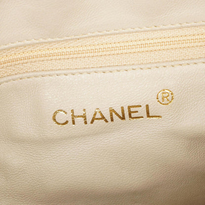 Chanel Camera Tasche aus beigem gestepptem Lammleder mit Quaste und CC