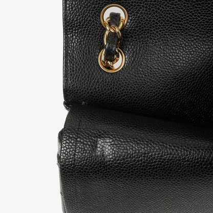 Chanel Jumbo Classic Double Flap Tasche aus schwarzem gestepptem Kaviarleder mit goldfarbenen Beschlägen