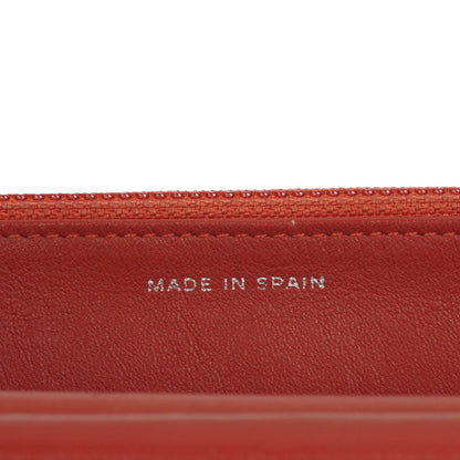 CHANEL Wallet on Chain WOC aus orangefarbenem gestepptem Lackleder mit pinkem CC-Logo und silberfarbenen Beschlägen