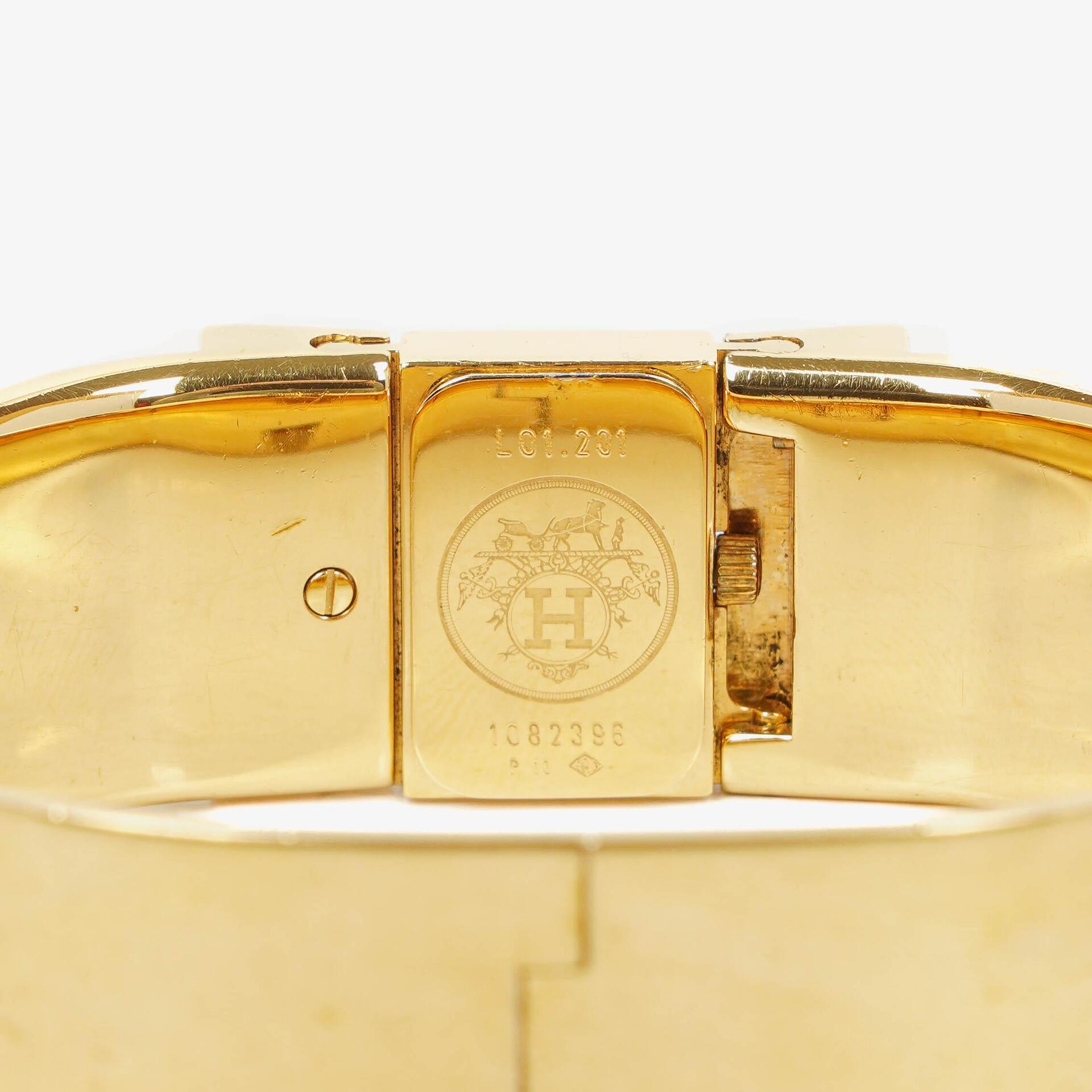 Hermès Loquet L01.201 Armreif-Quarzuhr aus schwarzem Reitsport-Emaille und vergoldetem Metall