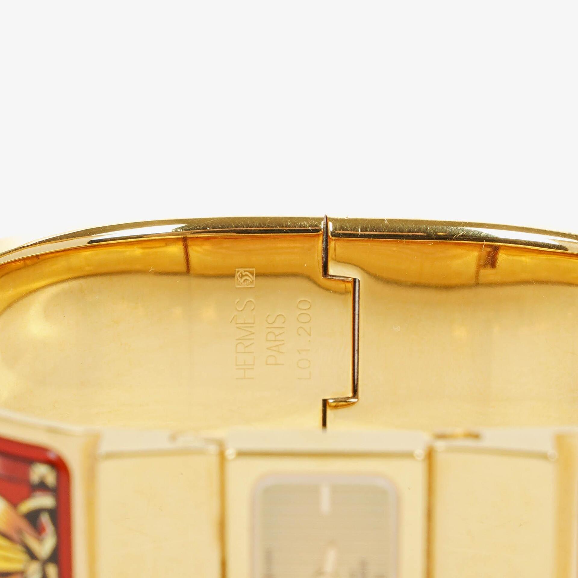 Hermès Loquet Armreif-Quarzuhr L01.200 mit rotem Reiter-Emaille und vergoldeten Details